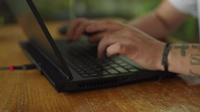 Close-up of coders hands typing on laptop, programming in a tech environment. Agile fingers navigate the keyboard, executing commands, debugging software, crafting code under a deadline pressure.