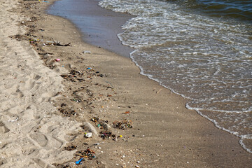 Dirty beach a lot of trash landscape.