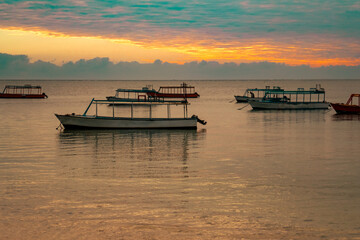 View of fishing boats against a golden sunrise at Malindi Beach in Kenya