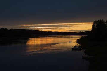 Dark sunset with silhouette of seashore.