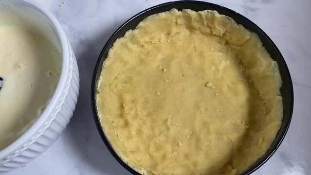 Filling a pie with fruits and sour cream , egg, sugar mixture