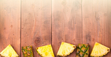 Fresh sliced pineapple with whole. On the wooden background. Free space for text . Top view