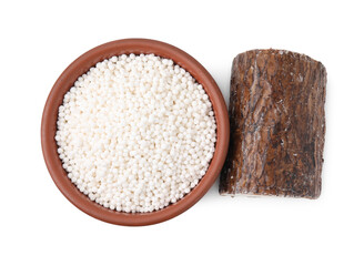 Tapioca pearls in bowl and cassava root isolated on white, top view