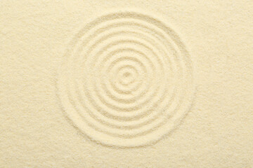 Zen rock garden. Circle pattern on beige sand, top view