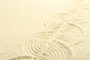 Fototapeta na wymiar Zen rock garden. Wave pattern on beige sand