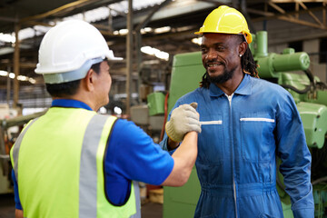 technician or engineer shaking hands with coworker before starting work in the factory