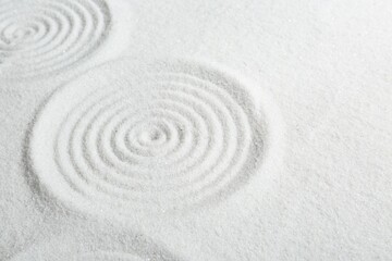 Fototapeta na wymiar Zen rock garden. Circle patterns on white sand