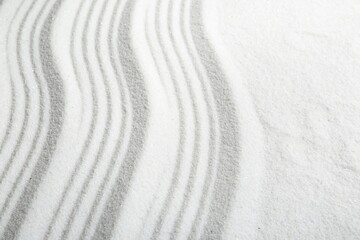 Fototapeta na wymiar Zen rock garden. Wave pattern on white sand