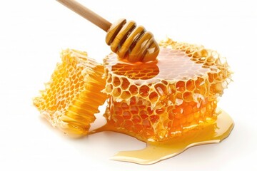 Honey dripping from a wooden honey dipper on a white background