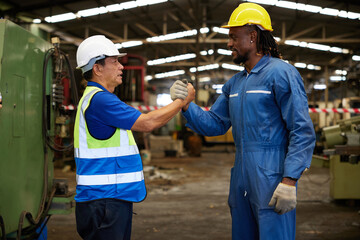 technician or engineer shaking hands with coworker before starting work in the factory