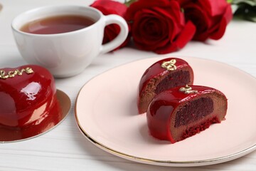 St. Valentine's Day. Pieces of delicious cake served on white table, closeup