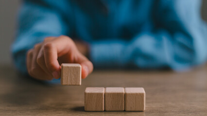 Blank wooden cubes on the table with copy space, empty wooden cubes for input wording, and an...