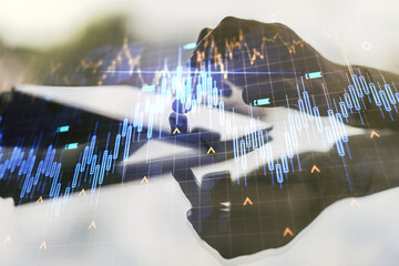 Double exposure of abstract creative financial chart with world map and with finger clicks on a...