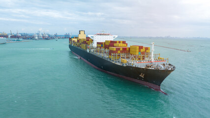 side view Cargo Container ship with contrail in the ocean ship carrying container and running for...