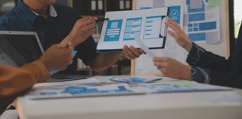 Close up ux developer and ui designer use augmented reality brainstorming about mobile app interface wireframe design on desk at modern office.Creative digital development agency