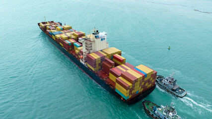 tug boat are pulling Cargo container ship to customs port import export goods to cargo yard port to...