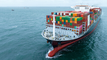 front view Cargo Container ship with contrail in the ocean ship carrying container and running for...