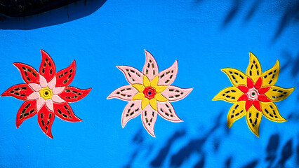  Image of flowers on a concrete wall decorating the temple area.