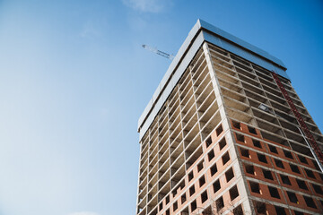 Obraz premium New modern apartment building under construction with blue sky background real estate concept