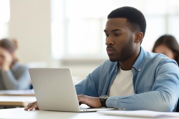 Fototapeta na wymiar man taking an online poll on his laptop in class