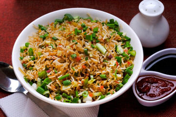 Chinese Cuisine - Fried Rice with Vegetables, fried rice in plate on table