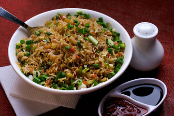 Chinese Cuisine - Fried Rice with Vegetables, fried rice in plate on table