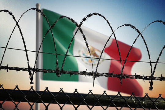 Mexican flag behind barbed wire fence. Illegal immigration and concept.