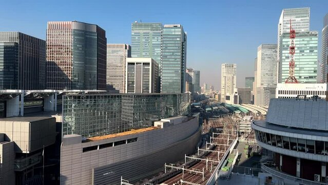 Tokyo cityscape with modern buildings, clear sky, no people, daytime, urban architecture, wide shot