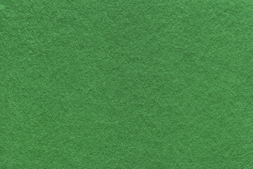 Texture of green and olive colors paper background, macro. Structure of dense craft cardboard.