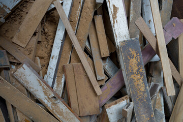 A messy heap of leftover wooden pieces is stacked in a pile. Top view
