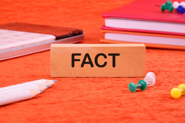 Fact Business Marketing Strategy Text Word written on a wooden block on an orange background next...