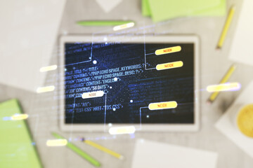 Abstract creative coding concept and modern digital tablet on background, top view. Multiexposure