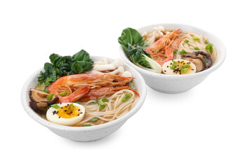 Delicious ramen with shrimps and eggs in bowls isolated on white. Noodle soup
