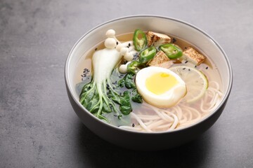 Bowl of vegetarian ramen on grey table, closeup