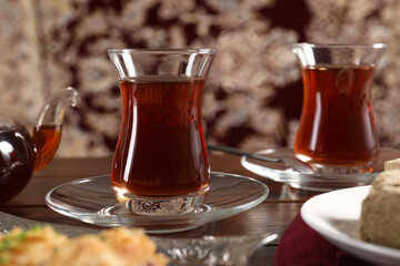 Traditional Turkish tea in glasses on wooden table, closeup