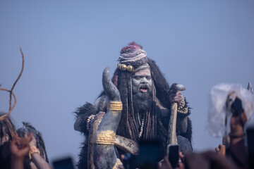 Masan Holi, Portrait of an male artist act as lord shiv with dry ash on face and body also in air...