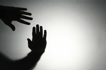 Silhouette of ghost behind glass against light background, closeup. Space for text