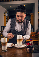 Barista decorating latte macchiato