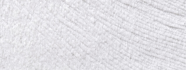 Texture of white woolen textile background from a soft wool material, macro. Fabric with wavy...