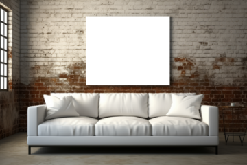 A sizable mockup positioned on a weathered brick wall, situated above a white couch, creating a striking contrast between the industrial backdrop and the minimalist furniture.