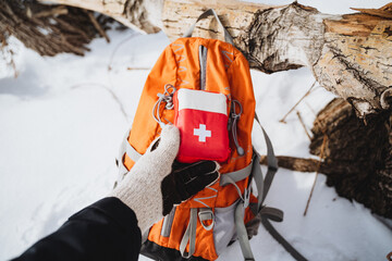 First aid kit in the backpack. Winter outdoor activities. Emergency medical supplies.