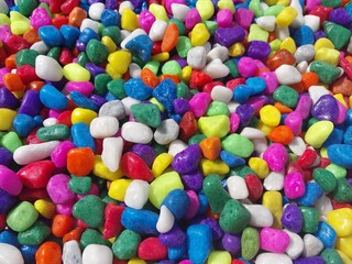 Beautiful multi-colored small rocks and pebbles. Colorful stones in different size and colors. Decorative item.