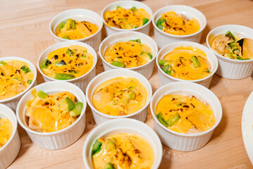 Cheddar Polenta and Asparagus Ramekin Dishes. Oven prepared ramekins filled with creamy polenta, tender asparagus, and rich cheddar sauce, served on a wooden table.