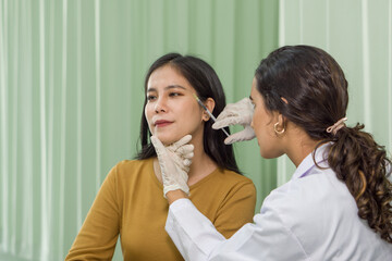 Doctor giving female patient medical injection in temporal. Atmosphere at cosmetic surgery...