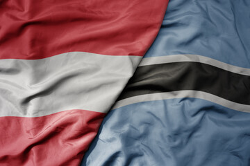 big waving national colorful flag of botswana and national flag of austria .