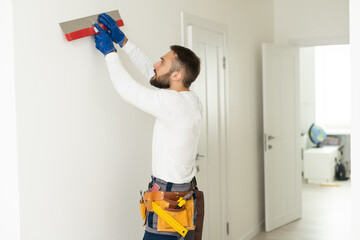 worker with a trowel on the wall