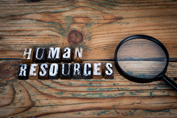 HUMAN RESOURCES. Alphabet letters on wood texture background