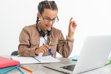Little girl learning English indoors at online lesson