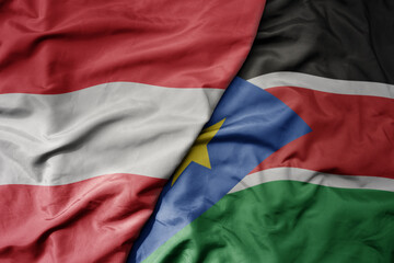 big waving national colorful flag of south sudan and national flag of austria .