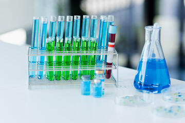 Asian female scientist or medical technician working with a blood lab test in the research lab, Healthcare and medical concept.